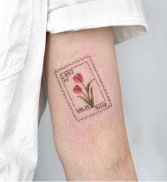 a postage stamp with flowers on the left arm and an envelope in the middle that says love