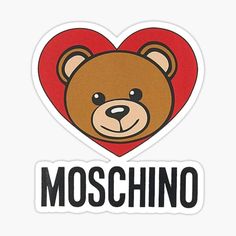 a brown teddy bear sitting on top of a white sign that says moschino