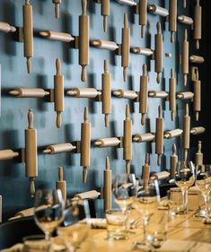 several wine glasses are lined up against a wall