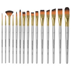 twelve makeup brushes with gold and silver handles, all lined up in a row on a white background