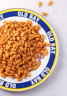 a white and blue plate with peanuts on it that says old bay dairy oil company