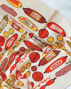 a kitchen towel with hotdogs and ketchup on it, sitting on a counter