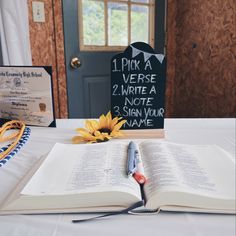 an open book and pair of scissors on a table