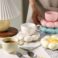 a table topped with eggs and cups of coffee