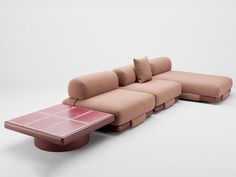 a couch and table sitting next to each other on a white surface in front of a wall