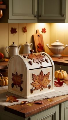 a kitchen counter topped with a wooden box covered in leaves