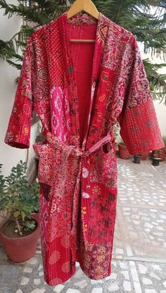 This Kimono is made of hand Kantha stitch fabric in patchwork . The fabric is a handmade printed fabric. Kantha stitch over the fabric gives it a unique look. It is two Layer of Cotton Kantha Stitch (Hand Quilted) Fabric Robe Size : Free size Length: 50 Inch ( 125 Cms.). Note: Due to patchwork theme there may be little difference in patches and color combination. Red Cotton Sleep Dress, Red Cotton Kimono With Long Sleeves, Red Cotton Long Sleeve Kimono, Red Long Sleeve Cotton Kimono, Long Red Kimono For Loungewear, Fitted Red Summer Kimono, Traditional Red Long Sleeve Robe, Traditional Red Robe With Long Sleeves, Traditional Long Red Robe