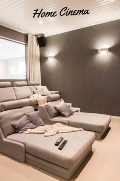 a living room filled with furniture and a flat screen tv sitting on top of a wall