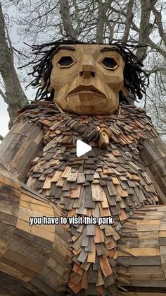 a wooden sculpture with words written on it that says you have to visit this park