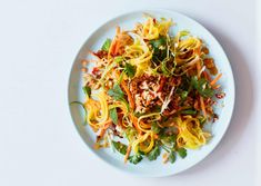 a white plate topped with noodles and vegetables