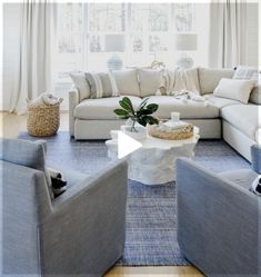 a living room filled with furniture and white walls