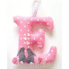 the letter e is decorated with pink and white polka dots