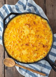 baked cheesy mac and cheese in a cast iron skillet with text overlay