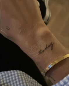 a person's wrist with a small heartbeat tattoo on the left side of their arm