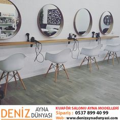 a row of white chairs sitting next to each other on top of a hard wood floor