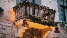 a balcony decorated with christmas lights and bells