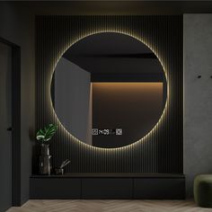 a round mirror in the middle of a room with lights on it and a green chair next to it