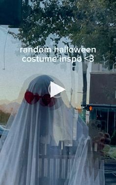 the ghost is dressed in white with red glasses and a long veil on it's head