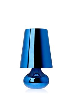 a blue table lamp sitting on top of a white surface