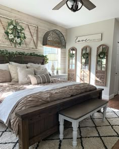 a large bed sitting inside of a bedroom on top of a rug