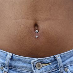 a woman's stomach with a single diamond in the middle of her tummy