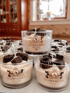 desserts are arranged in glass bowls on a table