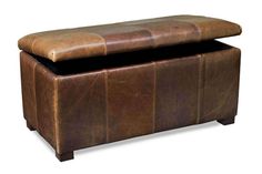 a large brown leather ottoman sitting on top of a white floor