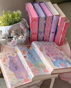 there is a mirror ball on the table next to books and a vase with flowers