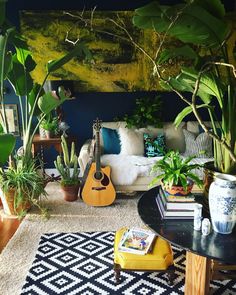 a living room filled with lots of plants and furniture