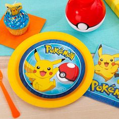 a pokemon themed birthday party with cupcakes, napkins and other items on the table