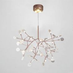 a chandelier with lights hanging from it's sides in a white room