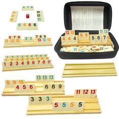 a set of wooden numbers and dominos in a case with instructions for each game