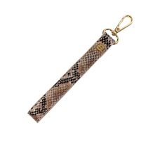 Say goodbye to fumbling through your pockets or purse, desperately searching for your keys. The Gold Python Wristlet Lanyard Key Strap is the ultimate accessory for the modern, on-the-go individual. With our wrist key strap, your keys are always within reach, securely fastened to your wrist. But our wrist key straps aren’t just for keys - use it with any small item with a D-ring (such as our Small Makeup Bag) to increase the functionality with style. Features: Swivel Lobster Clip Premium Soft To Wristlet Lanyard, Gym Pool, Blessing Beads, Accessory Holder, Stationary Shop, Small Makeup Bag, Small Makeup, Python Print, Accessories Holder