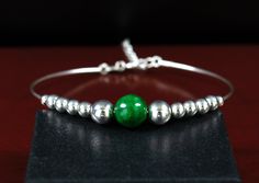 Beautiful 0.95mm .925 Sterling Silver wire bangle bracelet with .925 Sterling Silver beading with a AAA Quality Semi-Precious Dark Green Jade gemstone. Adjustable up to 8.5 inches. (Style # S004) ◭ JADE is a semi-precious gemstone has been known since ancient times to calm the soul and the mind, and create good luck. It's been used to heighten conscious levels, and to protect against evil. It is the gemstone of inner power that is used to bring your leadership qualities forward while increasing good judgement making. This is the overall Good Luck gemstone. If you wish for luck, Jade is a must have. ◭ SILVER: Silver brings many advantages to your life. It's known to carry the energies of the moon and is used to bring patience and perseverance. It's also known to attract and retain the quali Green Jade Bracelet, Wire Bangle Bracelets, Good Luck Bracelet, Bracelet Heart, Inner Power, Leadership Qualities, Jade Gemstone, Wire Bangles, Jade Bangle