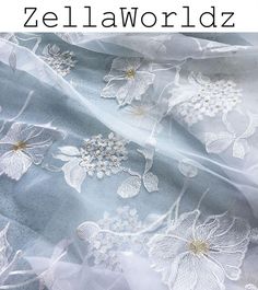 the fabric is white and has flowers on it, as well as text that reads zei