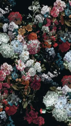 a bunch of flowers that are on the ground in front of a black background with red, white and blue flowers