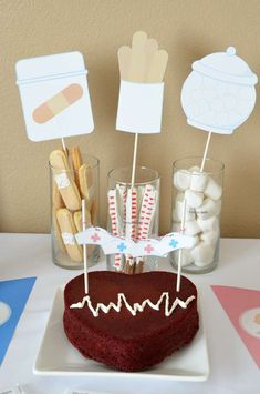 a heart shaped cake sitting on top of a table next to desserts and candies