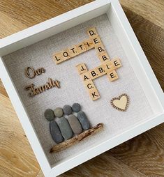 a white box with some rocks in it and words written on the inside that read one family