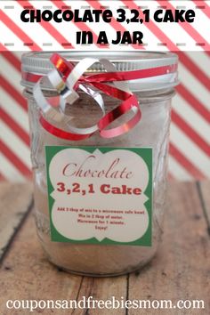 a jar filled with chocolate cake in a jar on top of a wooden table next to candy canes