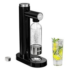 a drink dispenser with a glass next to it