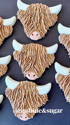 the cookies are decorated with icing and have long horns on them, as if they were buffalo heads