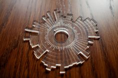 a wooden table with a circular object on it's surface and wood grain in the background