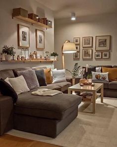 a living room filled with furniture and pictures on the wall