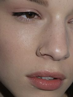 a close up shot of a woman's face with freckles on her nose