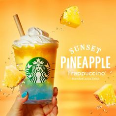 a hand holding up a starbucks drink with pineapple slices around it