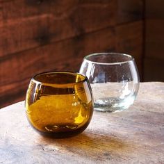 two glasses sitting on top of a wooden table