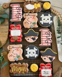 some decorated cookies are sitting on a cooling rack next to a tray with other decorations