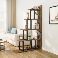 a living room with a white couch and wooden shelves filled with books on top of them