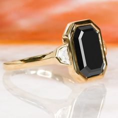 a close up of a black and white diamond ring