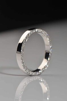 a diamond ring is shown on a reflective surface